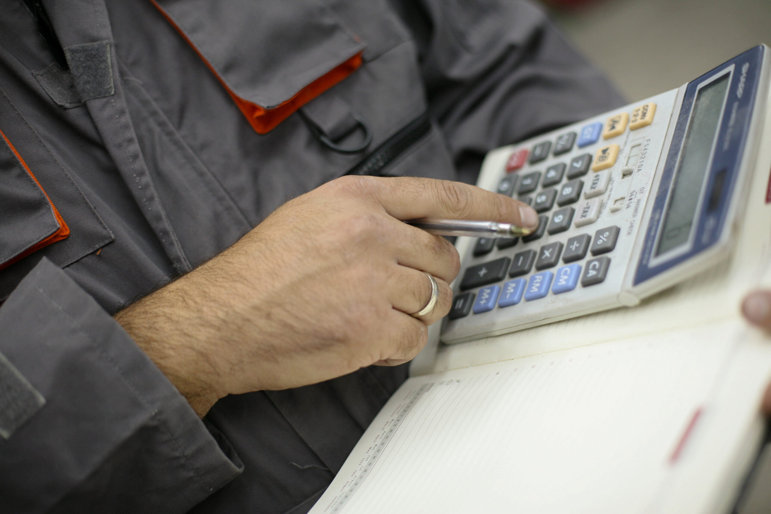 Worker counting on a calculator.