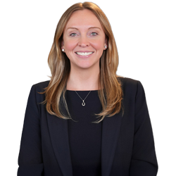 Profile headshot of Amanda McKenna in a black suit coat and black tshirt.