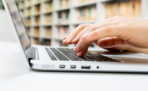 Image of hands typing on computer.