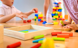 childcare benefits image - children playing with blocks