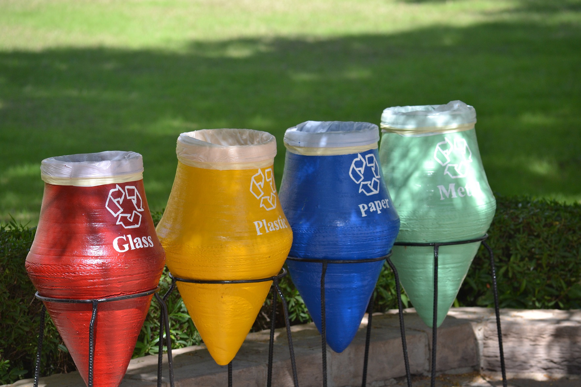 Is Recycling Worth It? Four colored recycling receptacles.