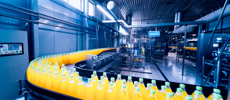 Beverage factory interior. Conveyor with bottles for juice.