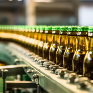 brown beverage bottle on a conveyor belt. beverage plant production line.