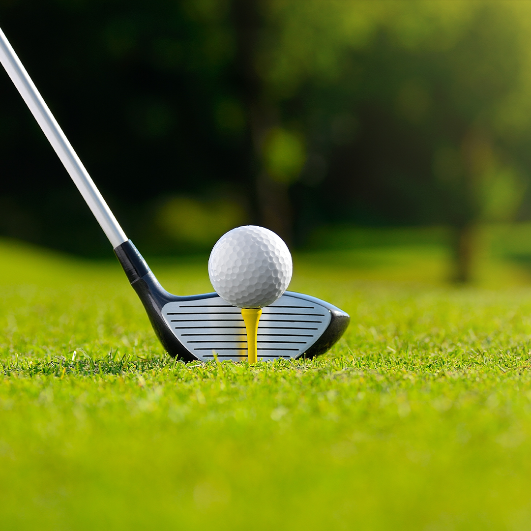 golf image of a club hitting a tee