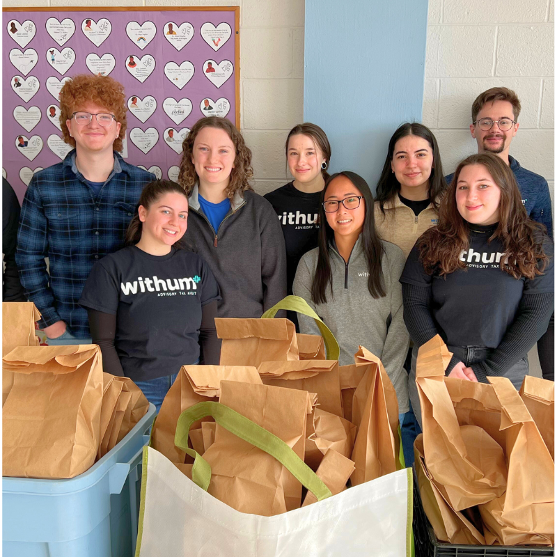 Withum's Winter Interns smiling in a volunteer event.