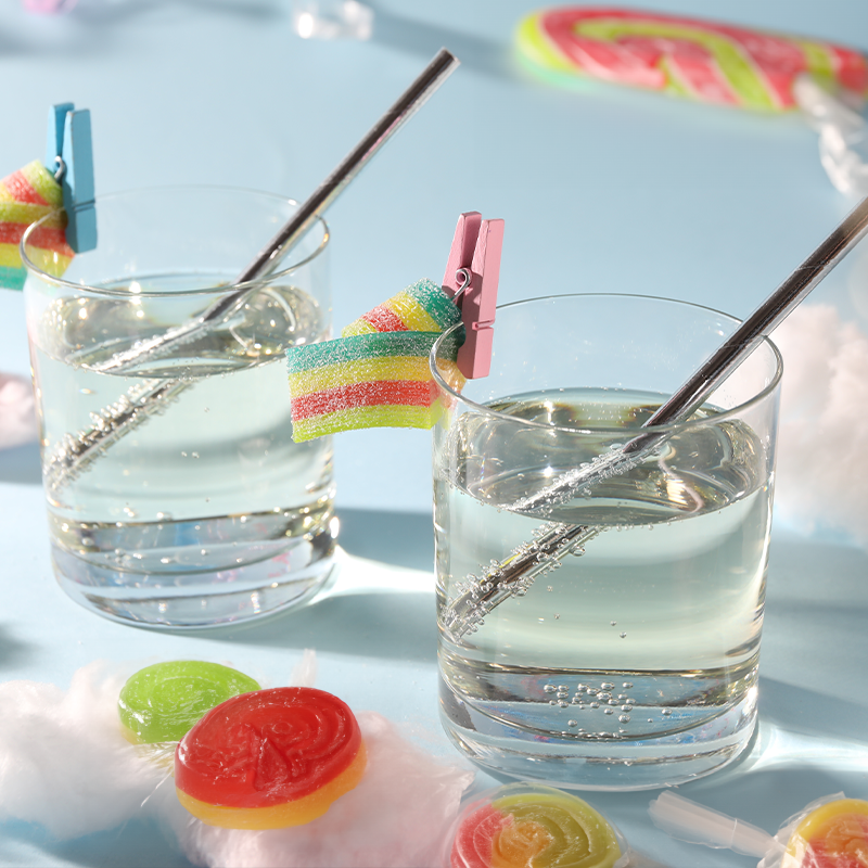 cocktails and confections - beverage with candy on the rim and table top