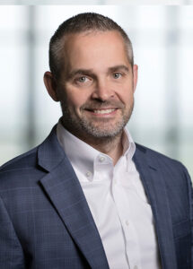 Profile headshot of Jamie Matte in a gray suit coat.
