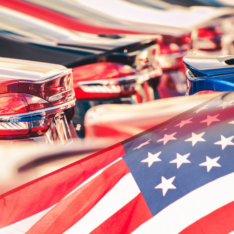 car dealership and an american flag