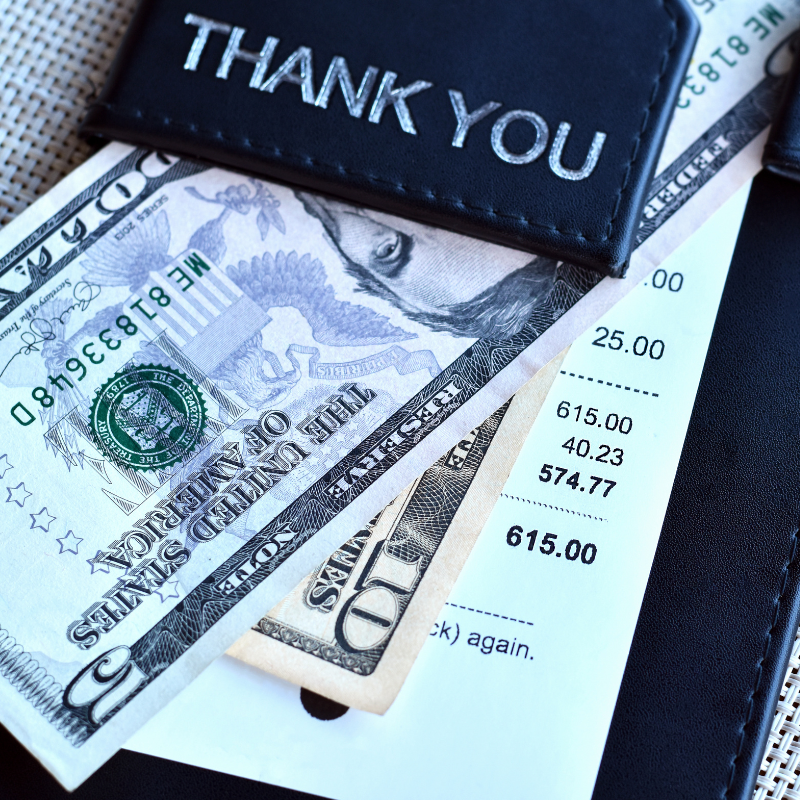 paying a restaurant bill and including tip
