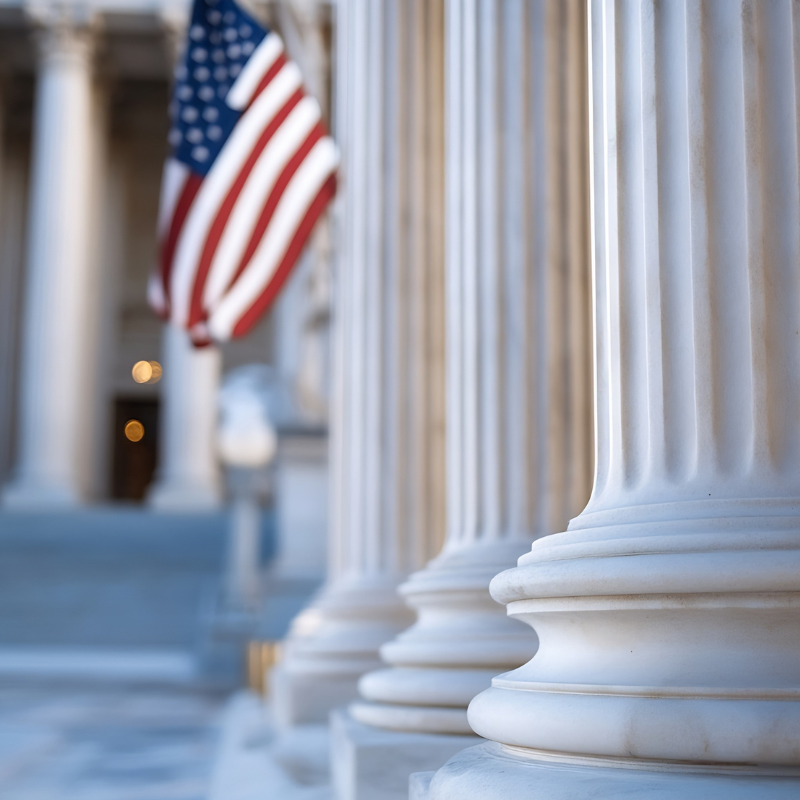 exterior of a courthouse with an american flag