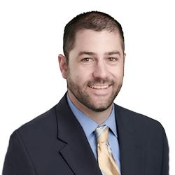 Profile headshot of Ian A. Johnston in a black suit coat.