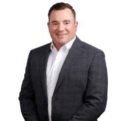 Profile headshot of Michael J. Schoell in a gray suit coat.