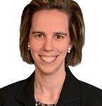 Profile headshot of Susan McGuire in a black suit coat.