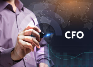 A man in a dress shirt points at a digital interface displaying a world map, graphs, and the acronym "CFO".