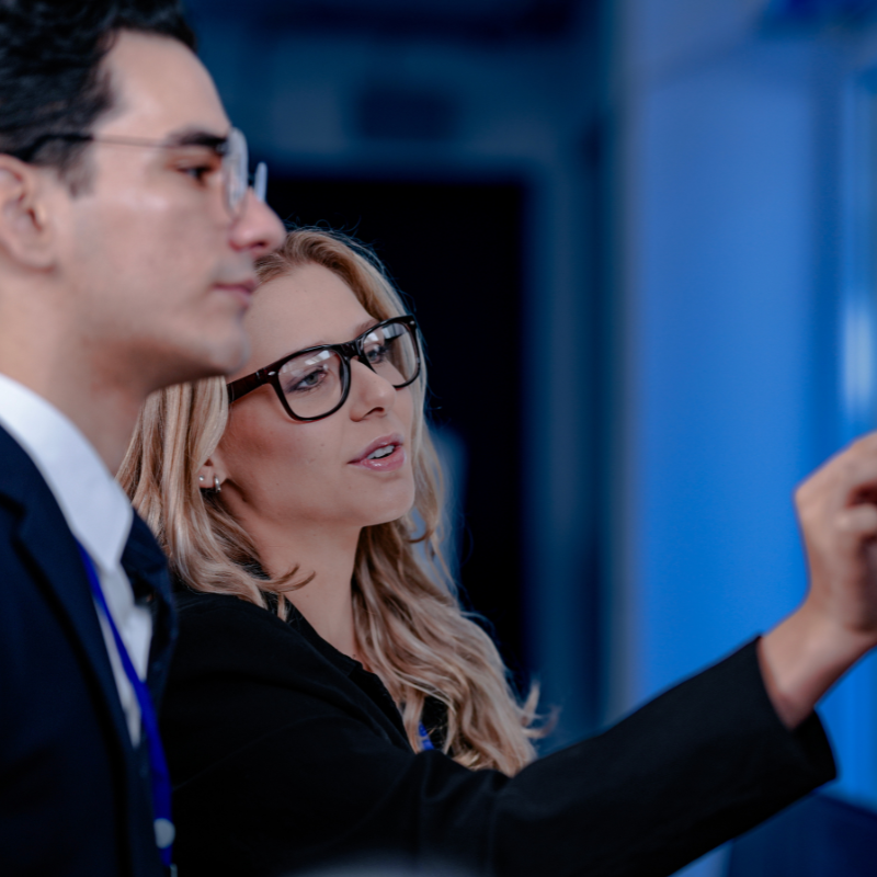 co-workers reviewing ai analysis data on digital screen.