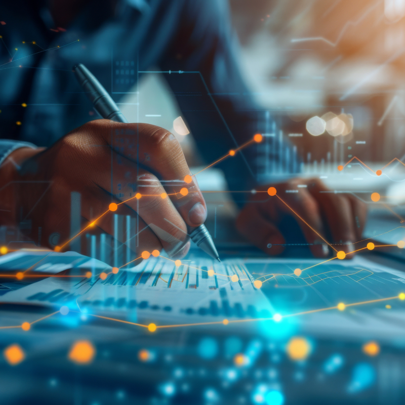 A person analyzes financial statements with glowing digital data overlays, indicative of futuristic technology in business.