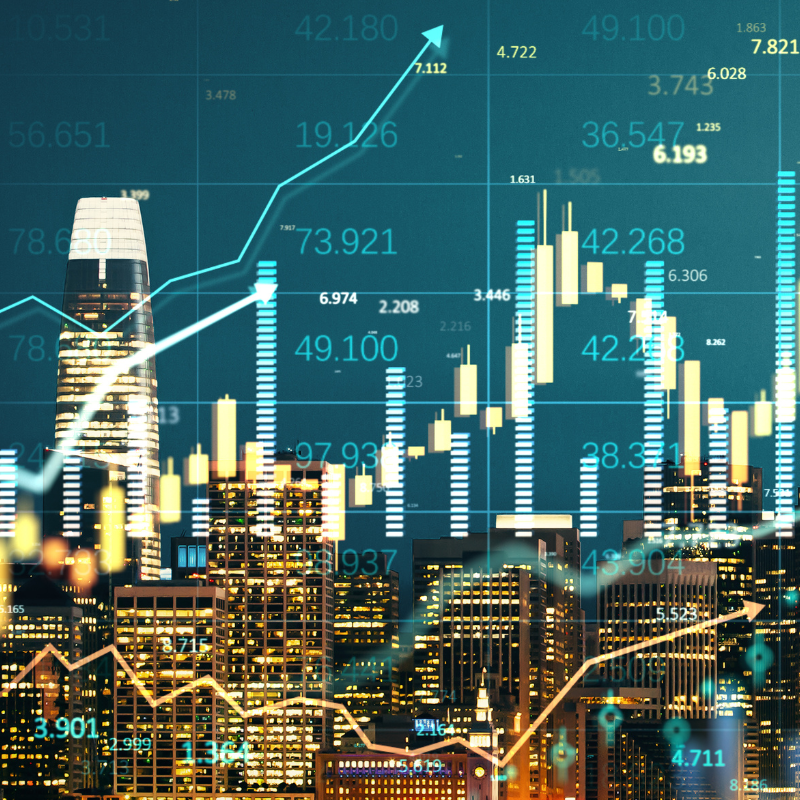 financial markets data overlay on california city skyline in the evening.
