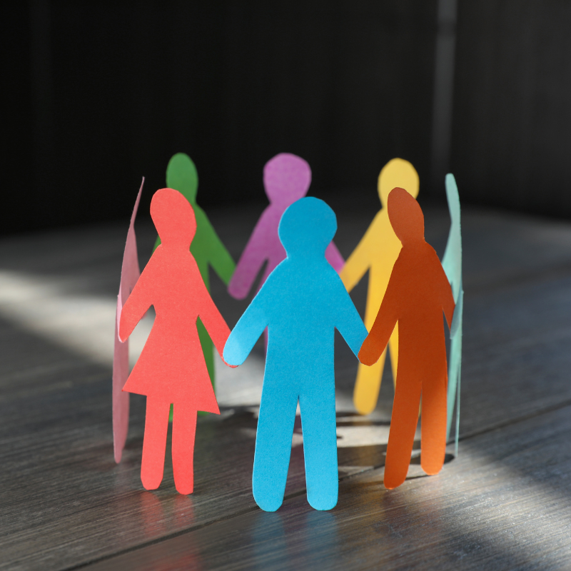 colorful shapes of people holding hands to show inclusion