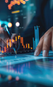 Hands analyzing financial charts and bar graphs on a digital display.
