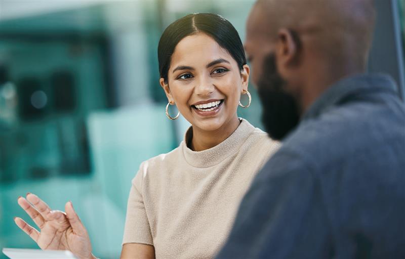 Two team members talking in a business setting.