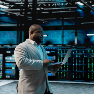 Data center software developer using laptop to audit systems.