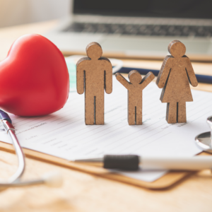 wooden figures representing family health insurance.