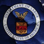 Flags of Department of Labor and USA painted on cracked wall