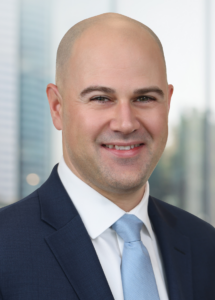 John Smith's photo in Blue blazer and white shirt with a blue tie.