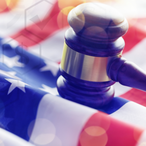 Judge's gavel on top of an american flag.