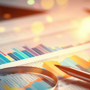 magnifying glass on a financial report with a pen