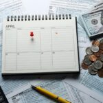 Tax Day Preparations with 1040 Forms Calendar Calculator and Money on a Busy Desk