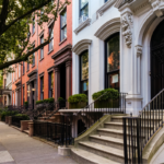 Brownstone facades & row houses at sunset in an iconic neighborhood of New York City.