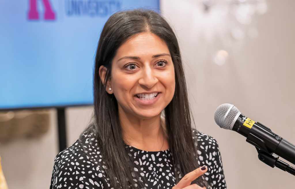 Fatema Raza smiling and holding her NJ Chamber of Commerce Young Professional Award.