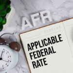 AFR - Applicable Federal Rate acronym on notepad, Business concept background